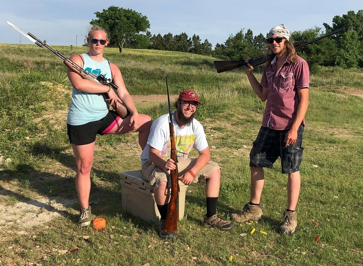 Hunter Brown (center) poses with other members of the Kansas John Brown Gun Club.