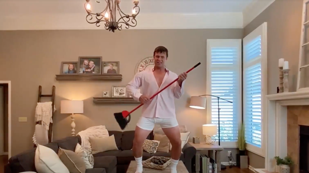 Realtor Jason Rains strums a broom in his "Risky Business" parody video.