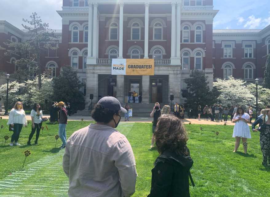 Mariah Doss and Juliana Tornabene wait to run through the columns in front of Jesse Hall on Saturday, April 24, 2021.