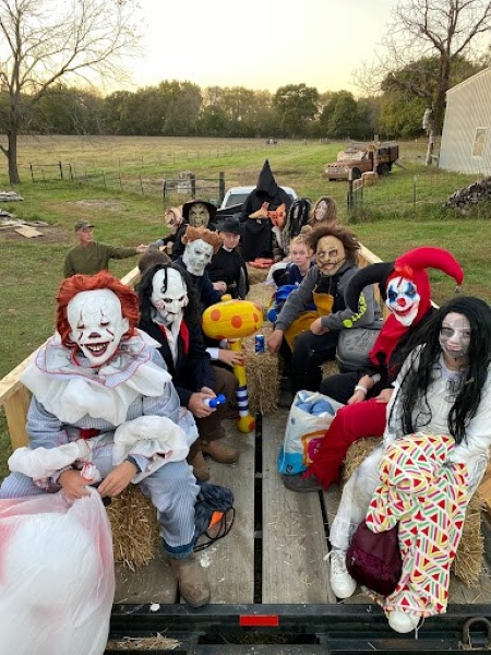 High school scarers pose before a night at The Grove Haunted Hayride.