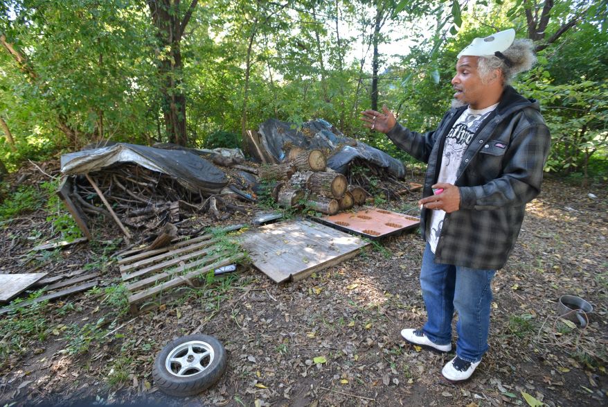 Kenneth Jenkins explains how he's tried to tidy up his back yard where he maintains his winter stock of firewood.