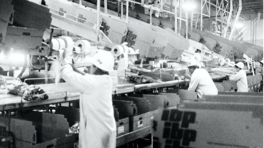 Workers cut and package beef in the early days of IBP's Finney County meatpacking plant.