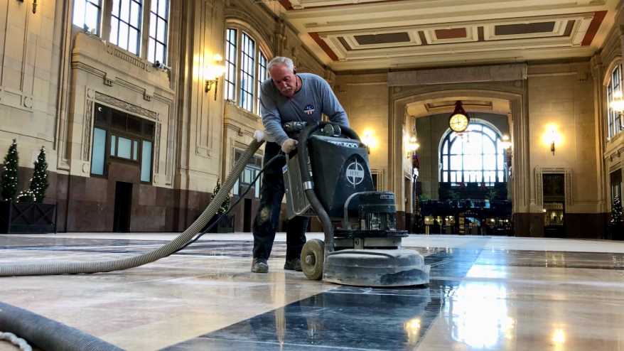 A worker polishing the granite floors of Union Station.