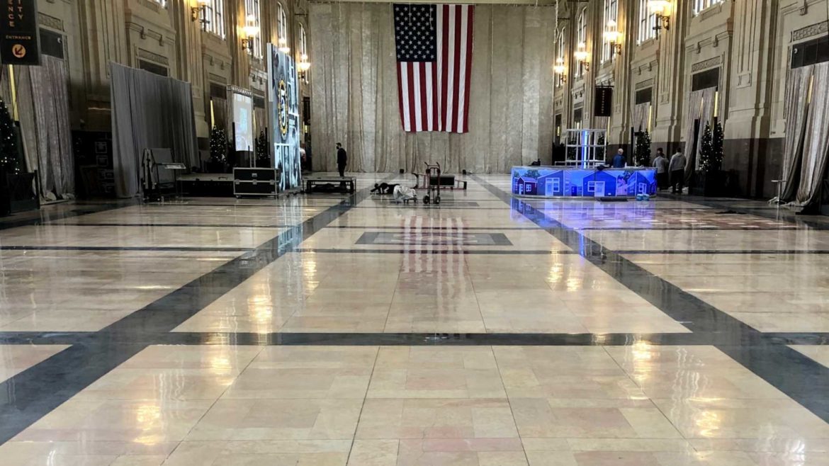 The American flag is reflected from the newly-polished floor of the Grand North Festival Plaza.