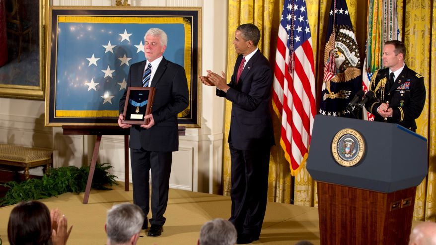 President Barack Obama applauded as Ray Kapaun, nephew of Chaplain (Captain) Emil J. Kapaun, U.S. Army, held the Medal of Honor President Obama awarded posthumously to Chaplain Kapaun in the East Room of the White House in Washington, Thursday, April 11, 2013. Chaplain Kapaun received the Medal of Honor posthumously for his extraordinary heroism while serving during combat operations at Unsan, Korea, and as a prisoner of war.