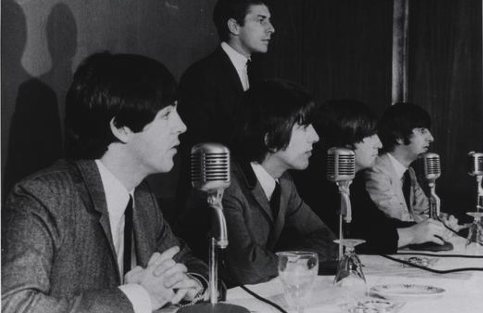 Before their September 1964 concert at Kansas City’s Municipal Stadium, the Beatles and press officer Derek Taylor met reporters at the Muehlebach Hotel.