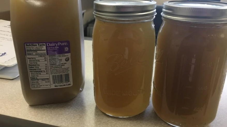 These jars contain brown water taken from a tap in Kewaunee County that researchers tied to spreading of manure on a nearby field in 2016. The soil from the field and water from the home shared the same signatures for fecal contaminants.