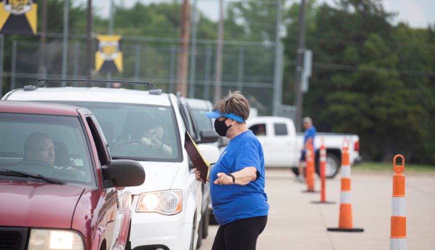 Connie Frederking of Wichita directed some of the 1,000 family participants toward the loading areas.