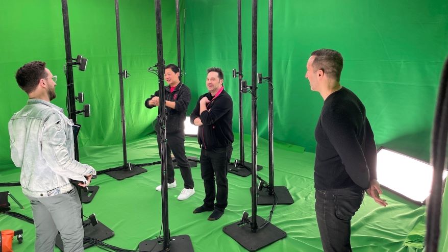 John Saw (second from left) and team in a studio surrounded by cameras capturing volumetric images to create holograms displayed on mobile devices.