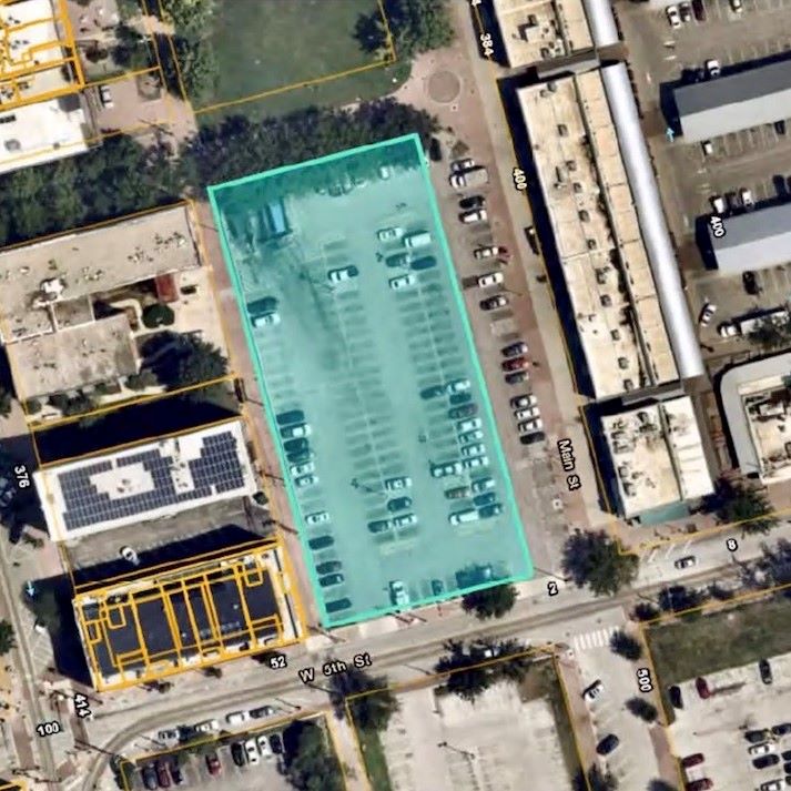 The proposed apartment tower would be located on a city-owned parking lot just west of the City Market.