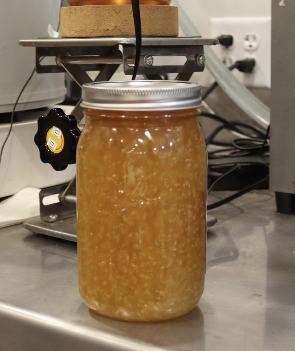 Once extracted and refined, CBD will crystalize, similarly to honey. Here a freshly extracted jar of CBD sits at Rural Route Hemp Co. in Adrian, Missouri.