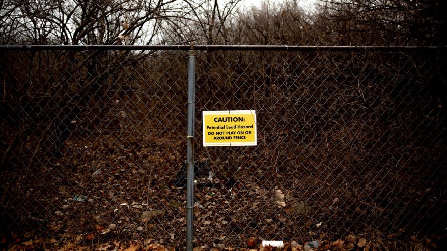 A sign warning of potential lead hazards on Feb. 11, 2022, at the site of the Pruitt Igoe Housing Apartment Complex in north St. Louis. The National Geospatial Intelligence Agency dropped the site as a potential space for its new headquarters, in part, due to the presence of toxins.