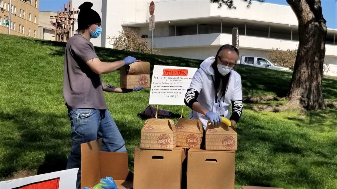 Kar Woo, right, handing out meals.