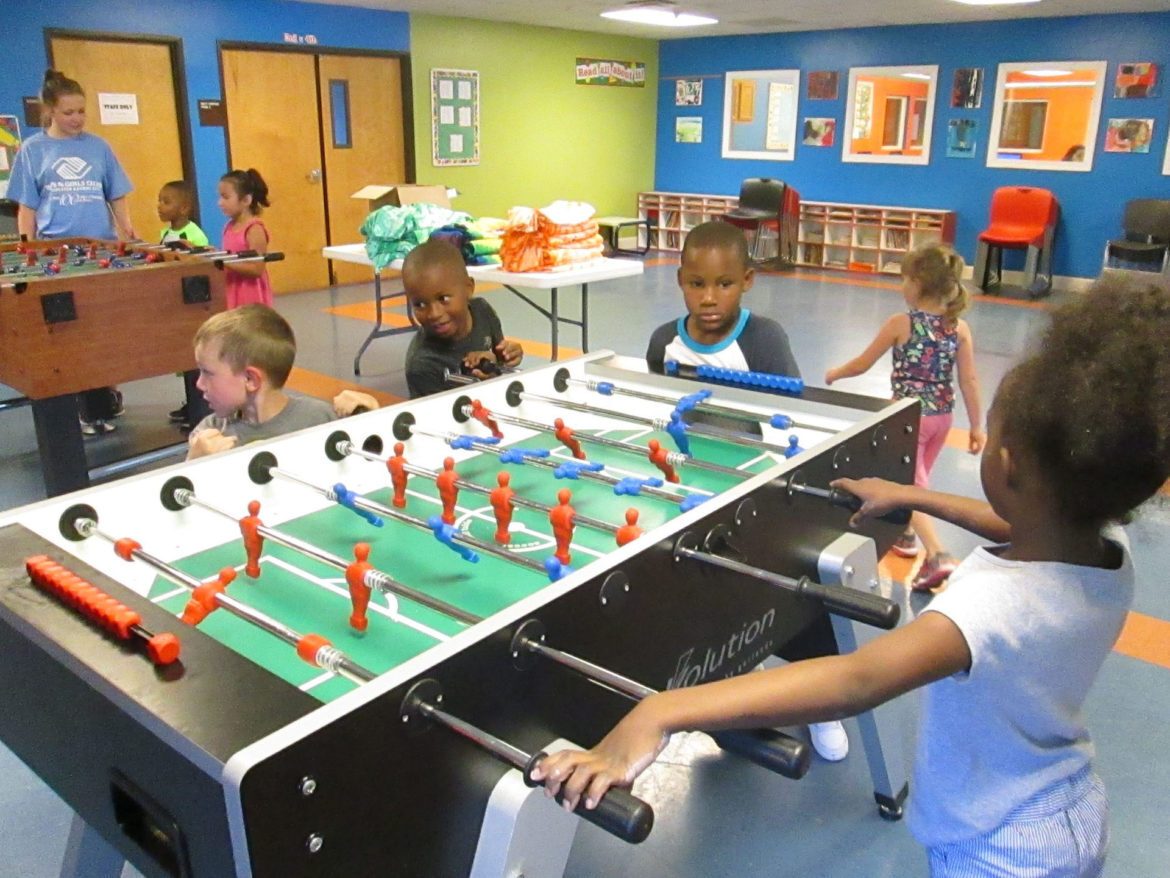 Boys & Girls Club kids playing foos ball