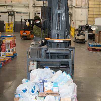 Food is loaded onto a forklift at Harvesters
