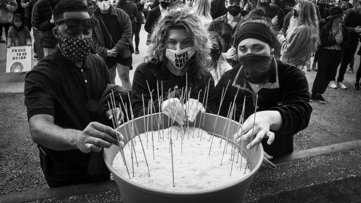 The crowd gathers to light incense in honor of the victims of the ATL shooting. (John McGrath | Flatland)
