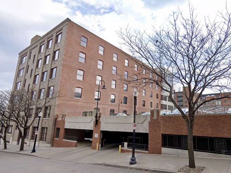 Developer Gary Hassenflu is proposing to renovate this building at 423 W. Eighth St. and add apartments above the garage in the foreground.