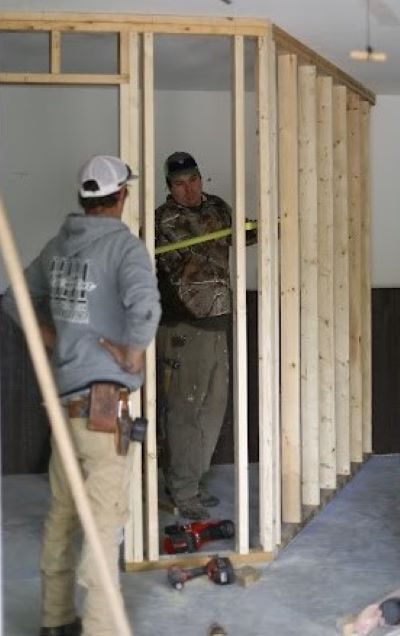 Alex Tripaldi, left, talks to Jeff Martin as they renovate a house.
