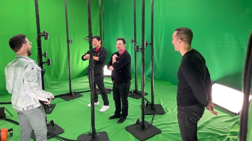 John Saw (second from left) and team in a studio surrounded by cameras capturing volumetric images to create holograms displayed on mobile devices.