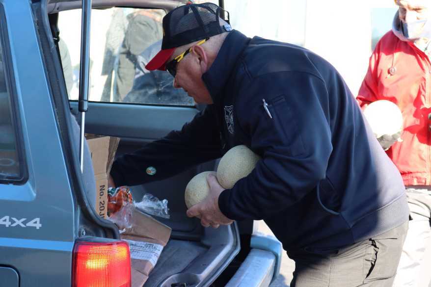 Volunteers fill the backs of cars with fresh food at the Tonganoxie mobile pantry. Most cars pick up for more than one family.