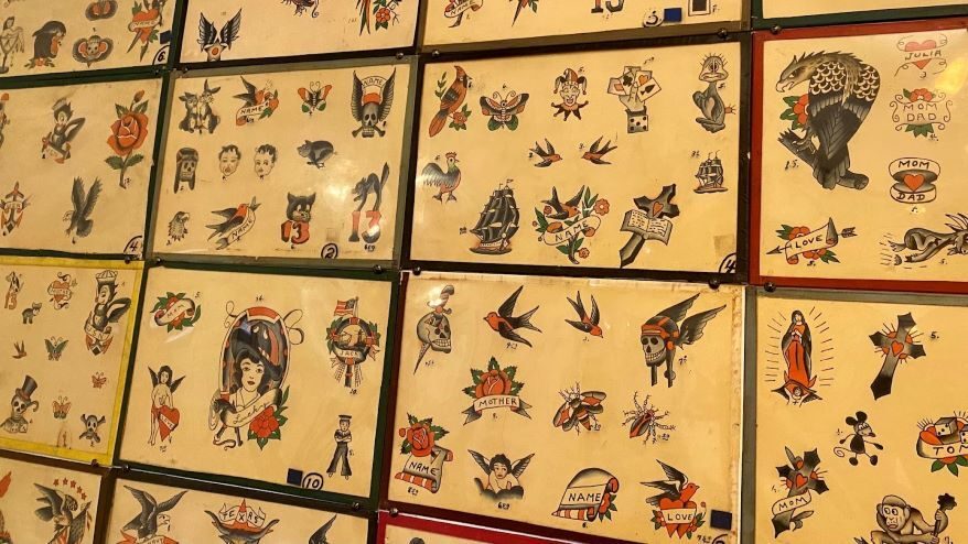 Decades of flash tattoo designs hang in Grimm Tattoo, many of them originally created by Bert Grimm.